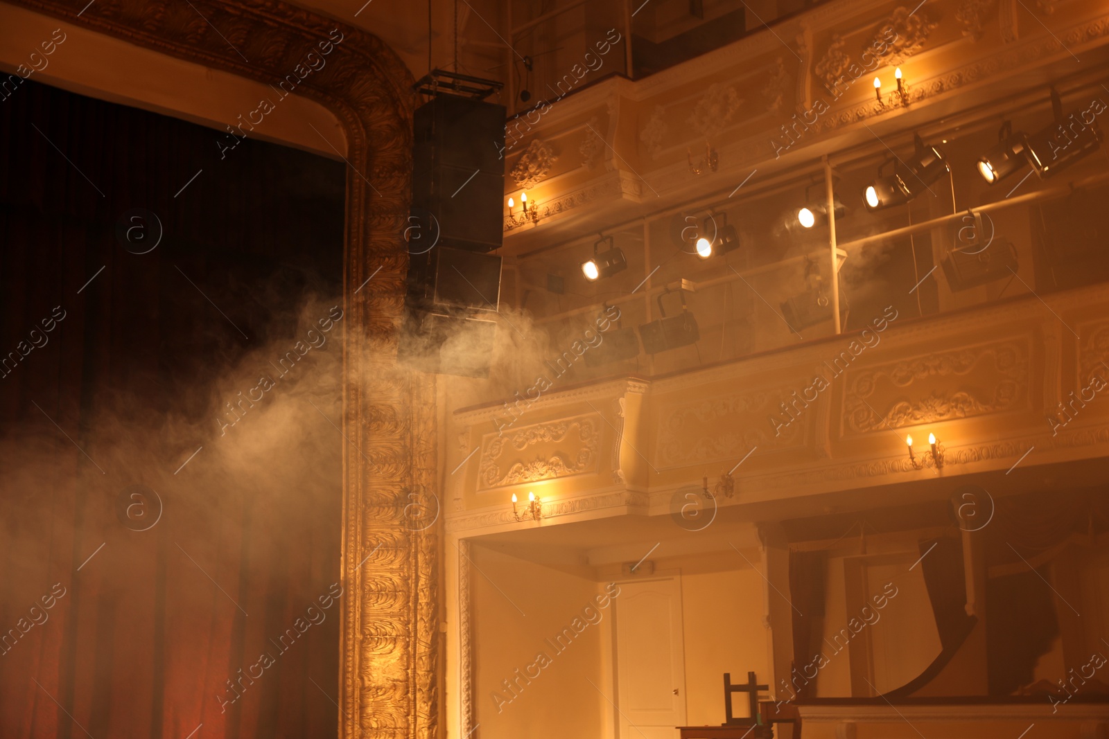 Photo of Professional spotlights and smoke in theatre, low angle view