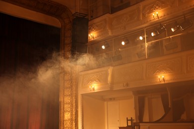 Photo of Professional spotlights and smoke in theatre, low angle view