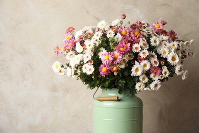 Photo of Beautiful flowers in modern vase on gray background, closeup, space for text