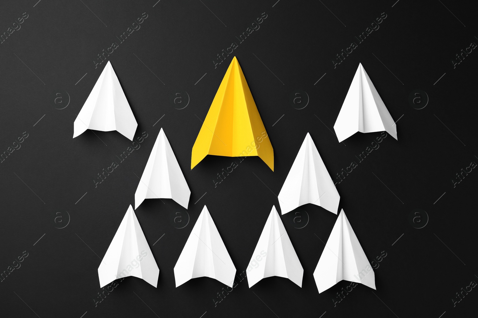 Photo of Paper planes on black background, top view