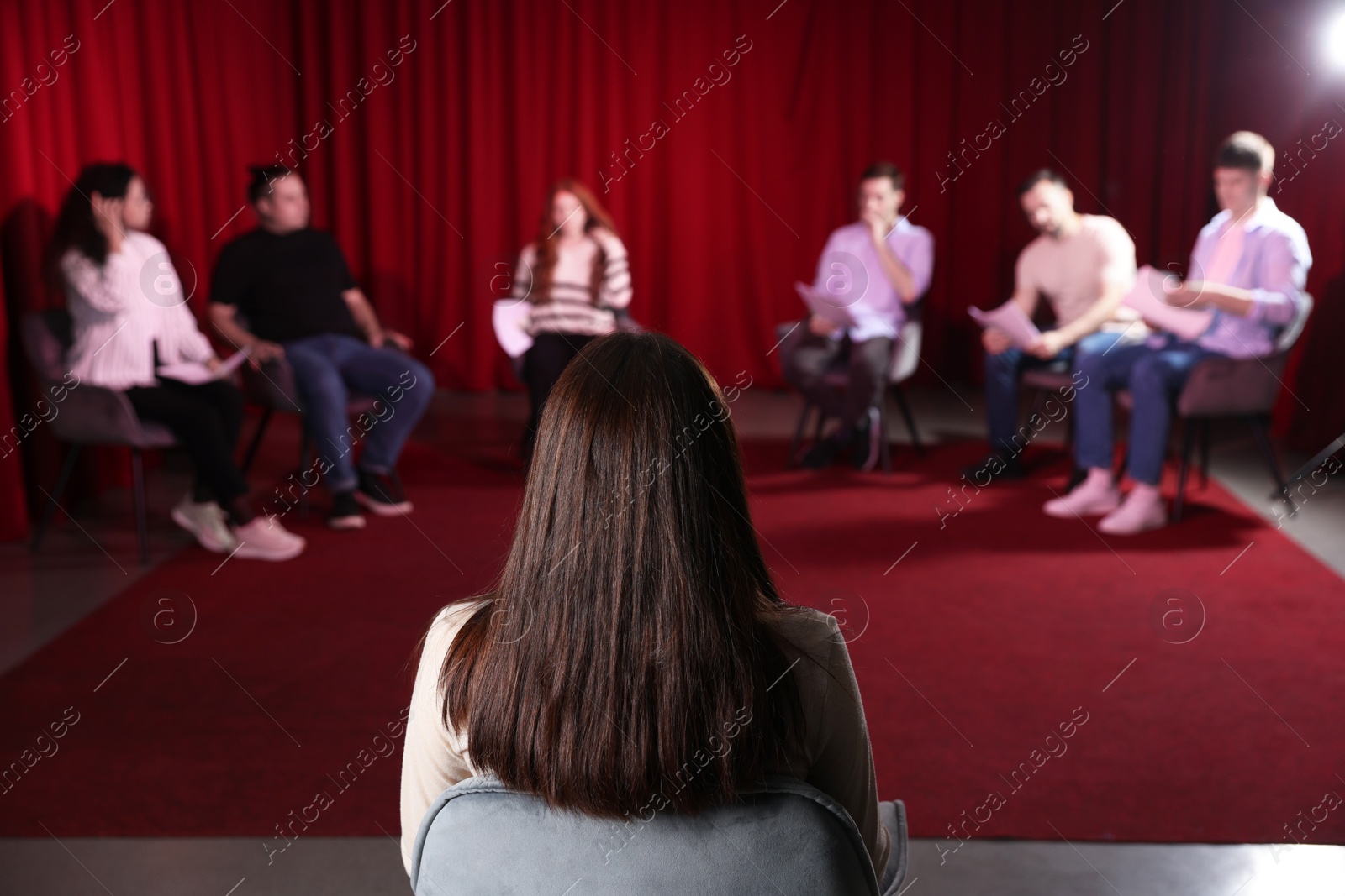 Photo of Professional actors reading their scripts during rehearsal in theatre