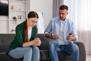 Photo of Upset woman ignoring her husband at home