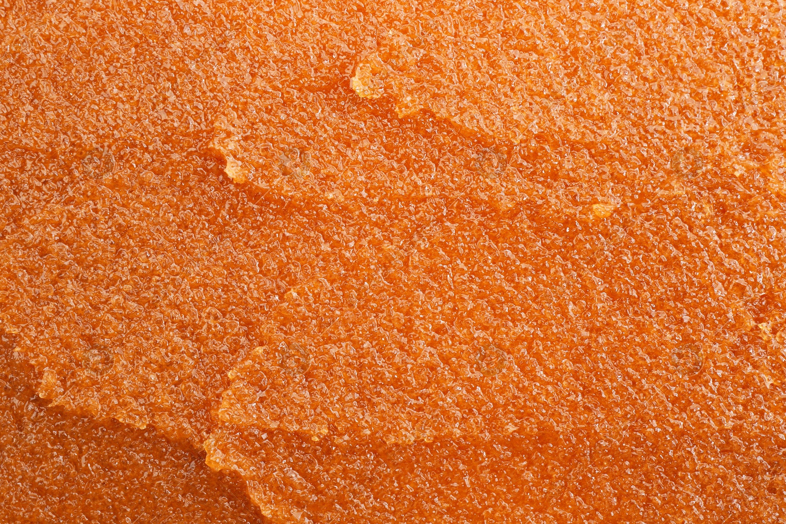 Photo of Sample of natural body scrub as background, closeup