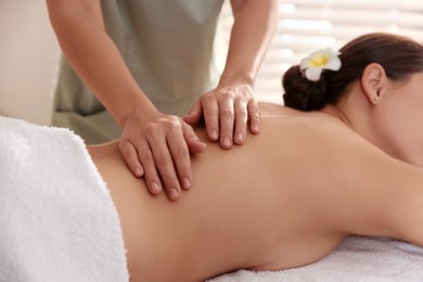 Photo of Woman receiving massage in spa salon, closeup