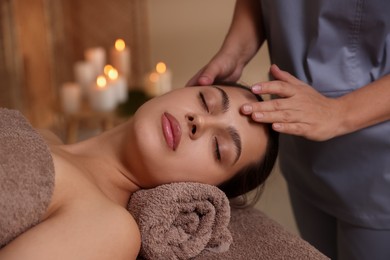 Photo of Woman receiving face massage in spa salon