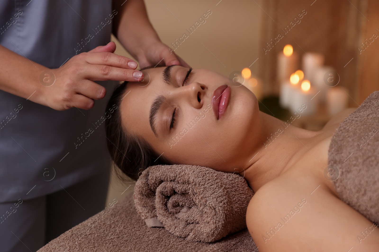 Photo of Woman receiving face massage in spa salon