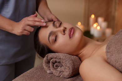 Photo of Woman receiving face massage in spa salon