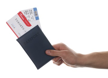 Photo of Travel agency. Man holding passport with flight tickets on white background, closeup