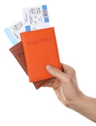 Photo of Travel agency. Man holding passports with flight tickets on white background, closeup