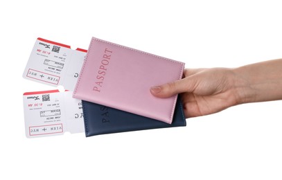 Photo of Travel agency. Woman holding flight tickets and passports on white background, closeup