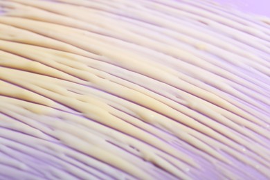 Photo of Cream sample on violet background, closeup view