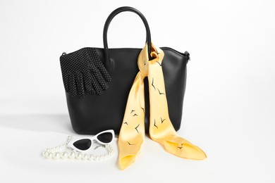 Photo of Stylish bag and other accessories on white background