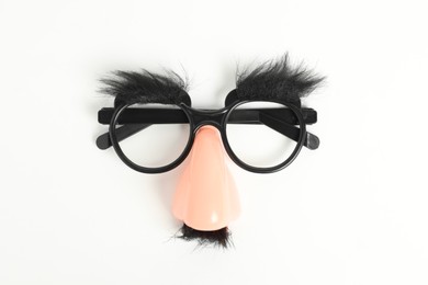 Photo of Funny mask with fake mustache, nose and glasses on white background, top view