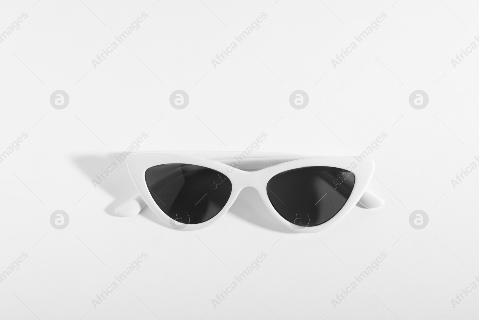 Photo of Stylish sunglasses on white background. Elegant accessory