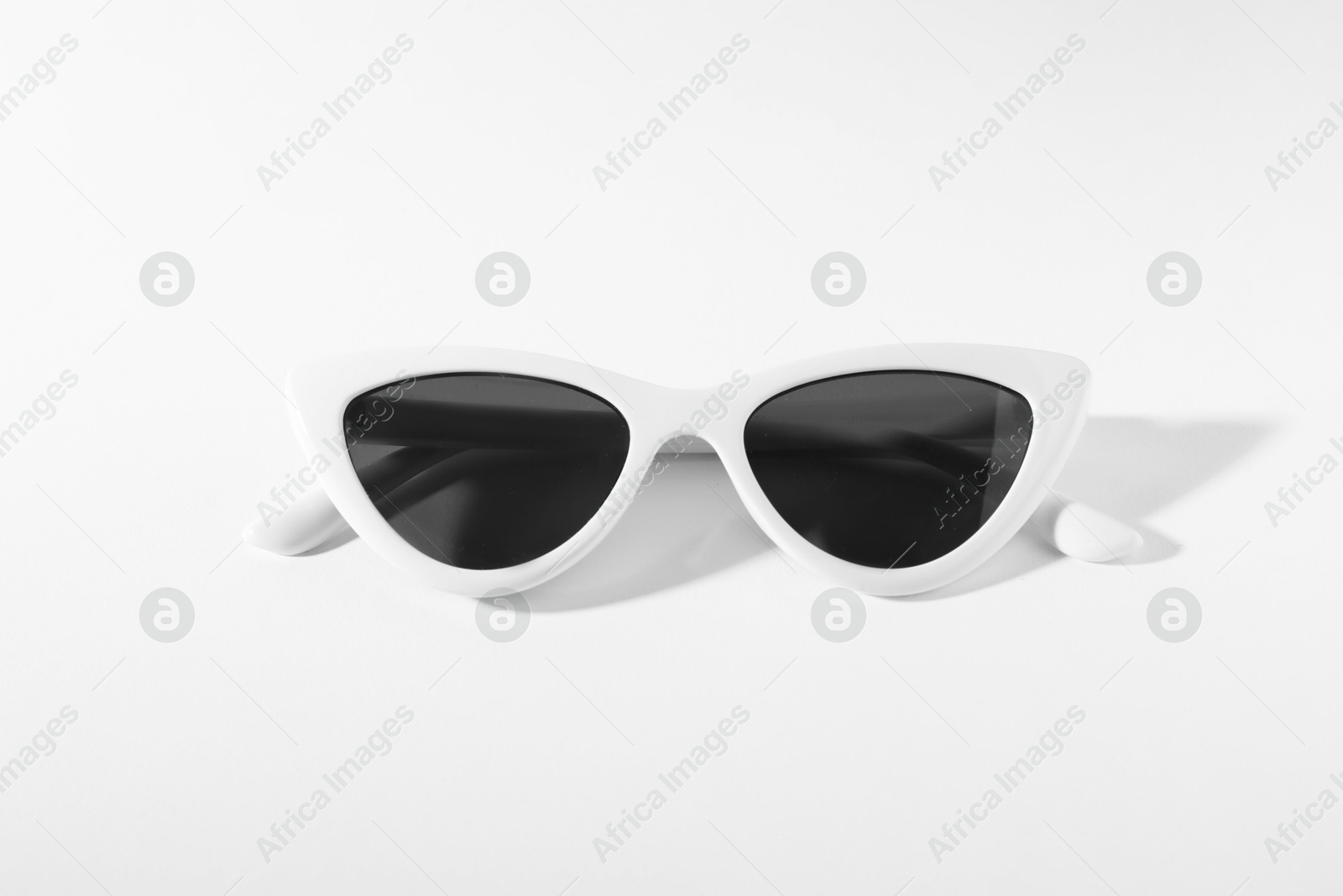 Photo of Stylish sunglasses on white background. Elegant accessory