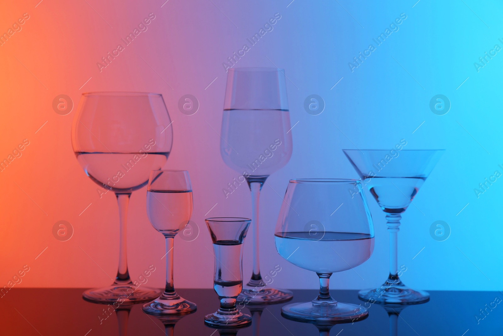 Photo of Different glasses with water on table, color tone effect