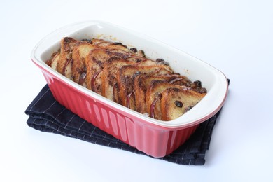 Photo of Delicious bread pudding in baking dish isolated on white