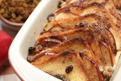 Photo of Delicious bread pudding in baking dish on table, closeup