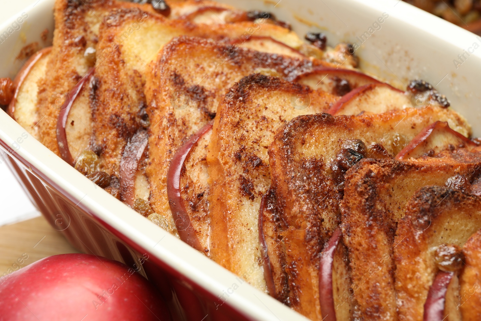 Photo of Delicious bread pudding in baking dish on table, closeup