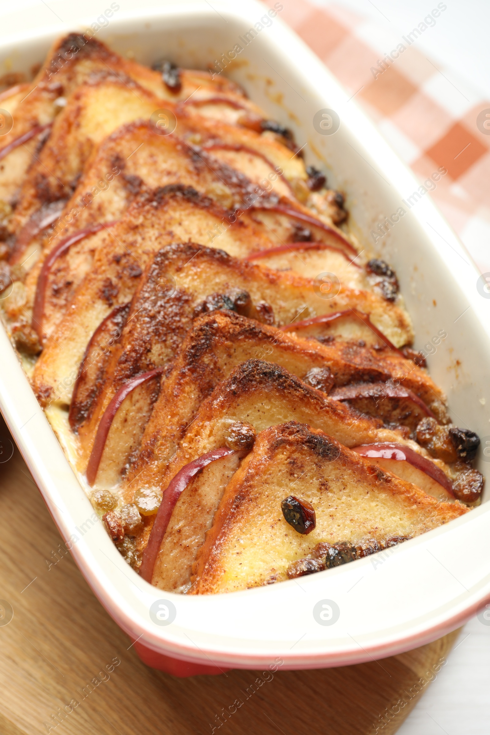 Photo of Delicious bread pudding in baking dish on table, closeup