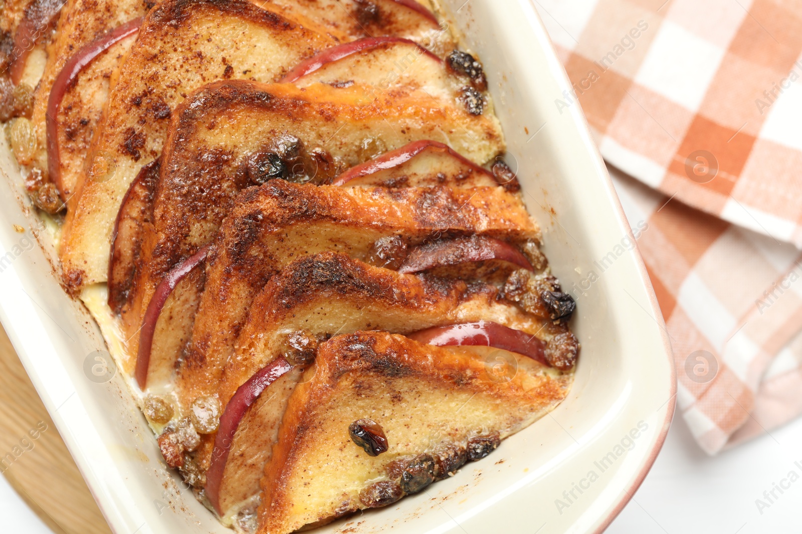 Photo of Delicious bread pudding in baking dish on table, top view