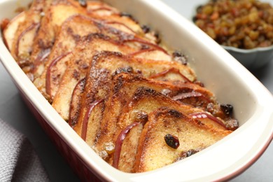 Photo of Delicious bread pudding in baking dish on table, closeup