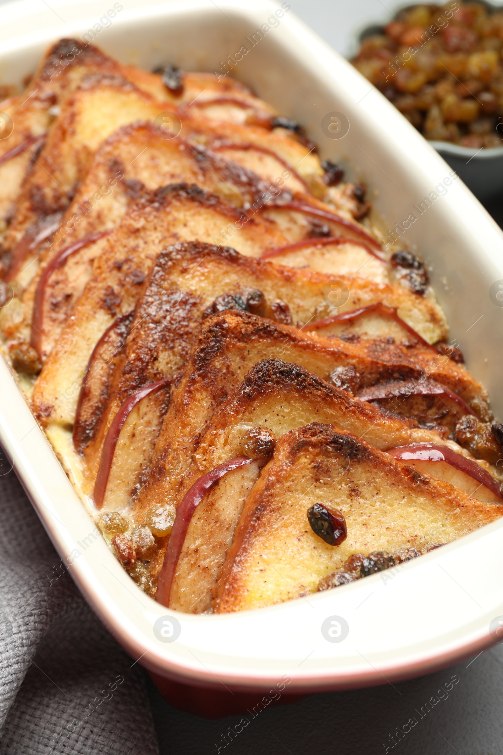 Photo of Delicious bread pudding in baking dish on table, closeup