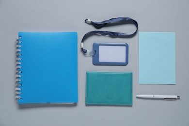 Photo of Different blank items for branding on gray background, flat lay. Mockup for design