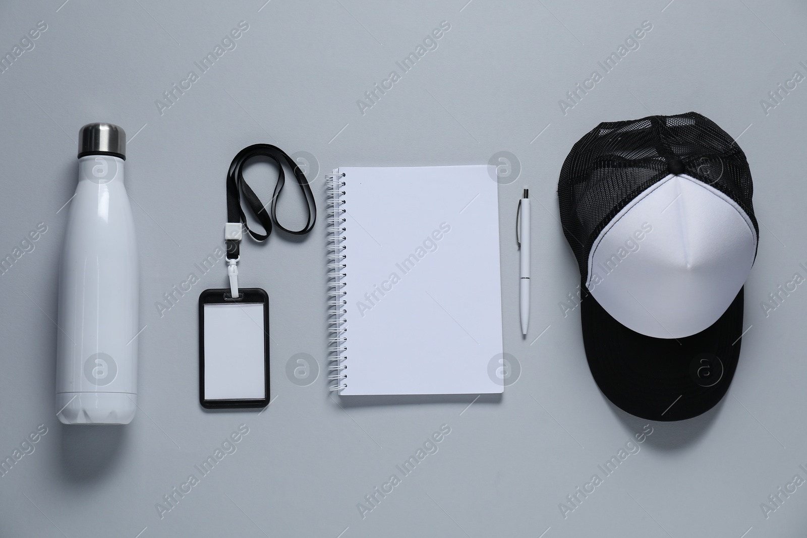 Photo of Different blank items for branding on gray background, flat lay. Mockup for design