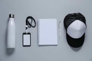 Photo of Different blank items for branding on gray background, flat lay. Mockup for design