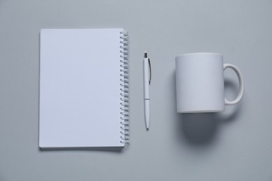 Photo of Different blank items for branding on gray background, flat lay. Mockup for design