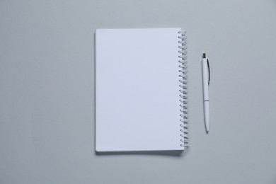 Photo of Blank notebook and pen for branding on gray background, flat lay. Mockup for design