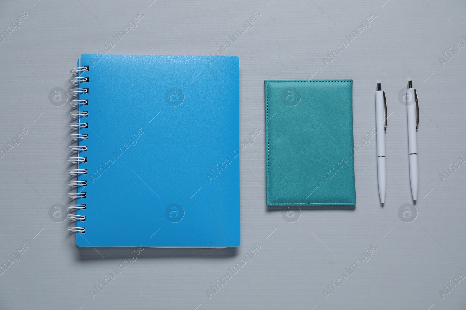 Photo of Different blank items for branding on gray background, flat lay. Mockup for design