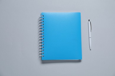 Photo of Blank notebook and pen for branding on gray background, flat lay. Mockup for design