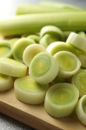 Photo of Fresh cut leeks on grey table, closeup