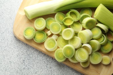 Photo of Fresh cut leeks on grey table, top view