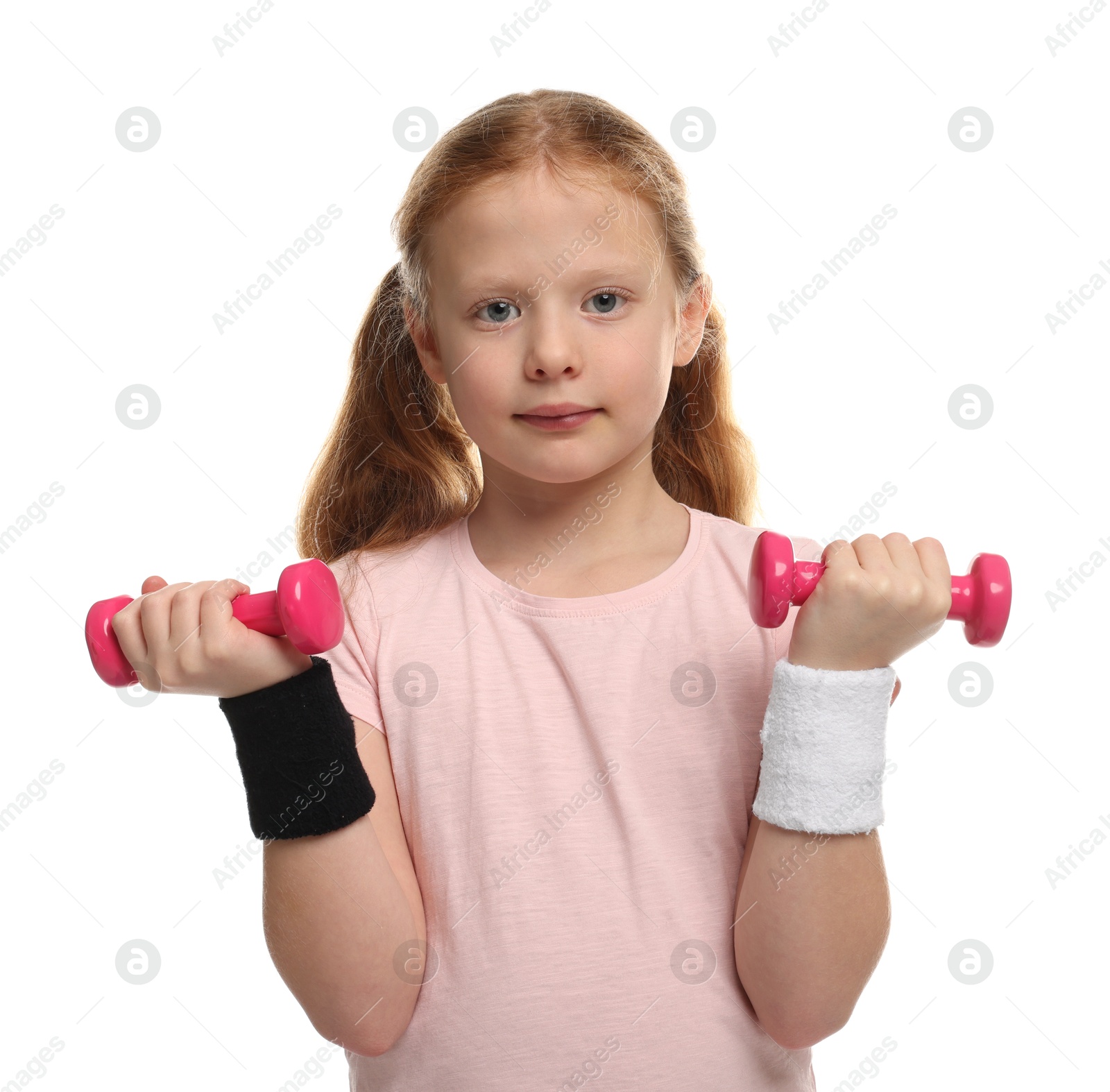 Photo of Cute little girl exercising with dumbbells on white background