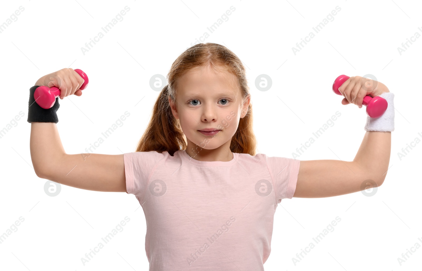 Photo of Cute little girl with dumbbells showing her biceps on white background