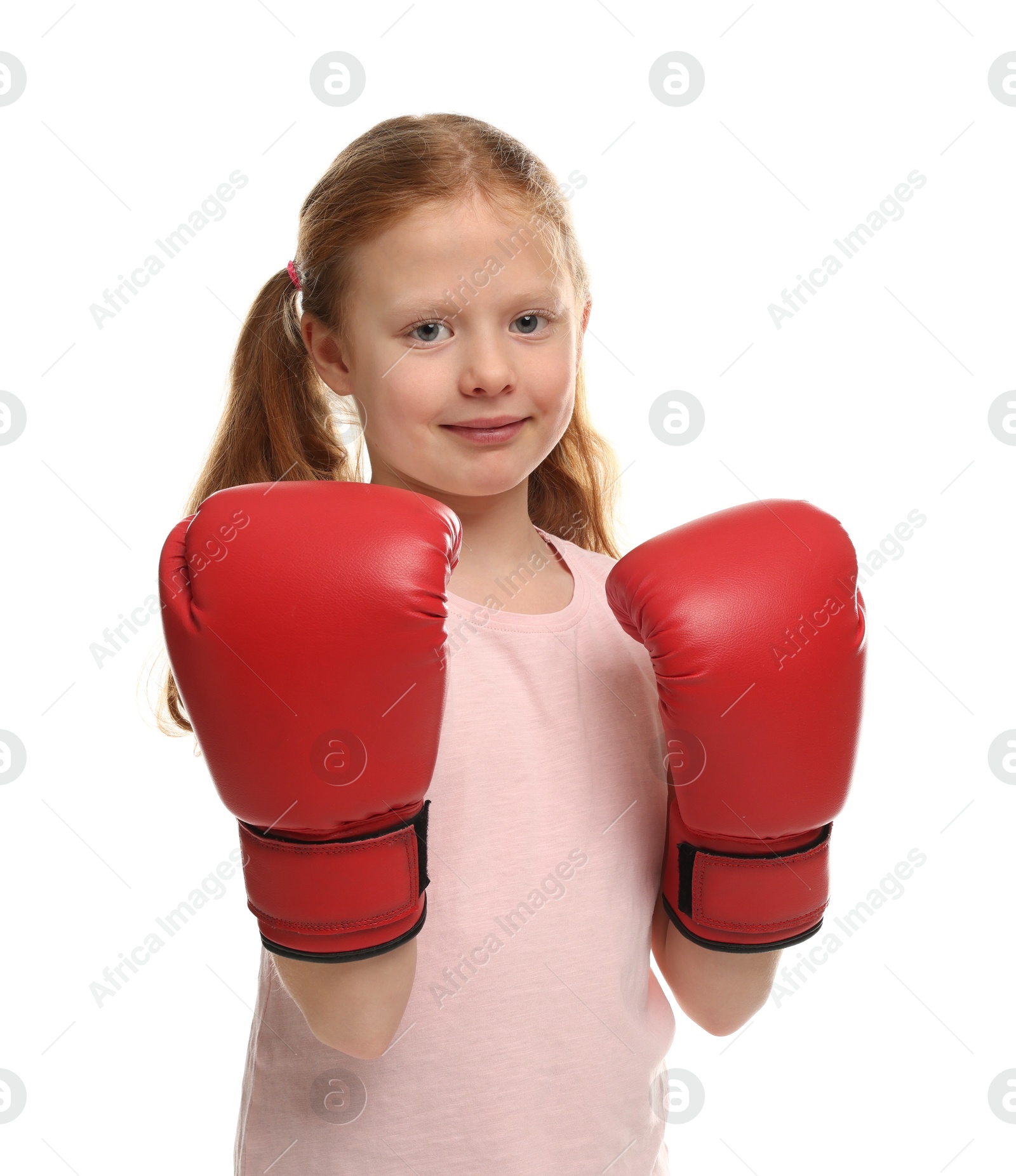 Photo of Cute little girl with boxing gloves on white background