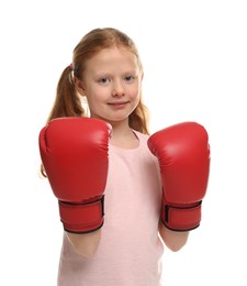 Photo of Cute little girl with boxing gloves on white background