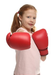 Photo of Cute little girl with boxing gloves on white background