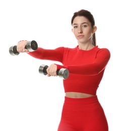 Woman in sportswear exercising with dumbbells on white background