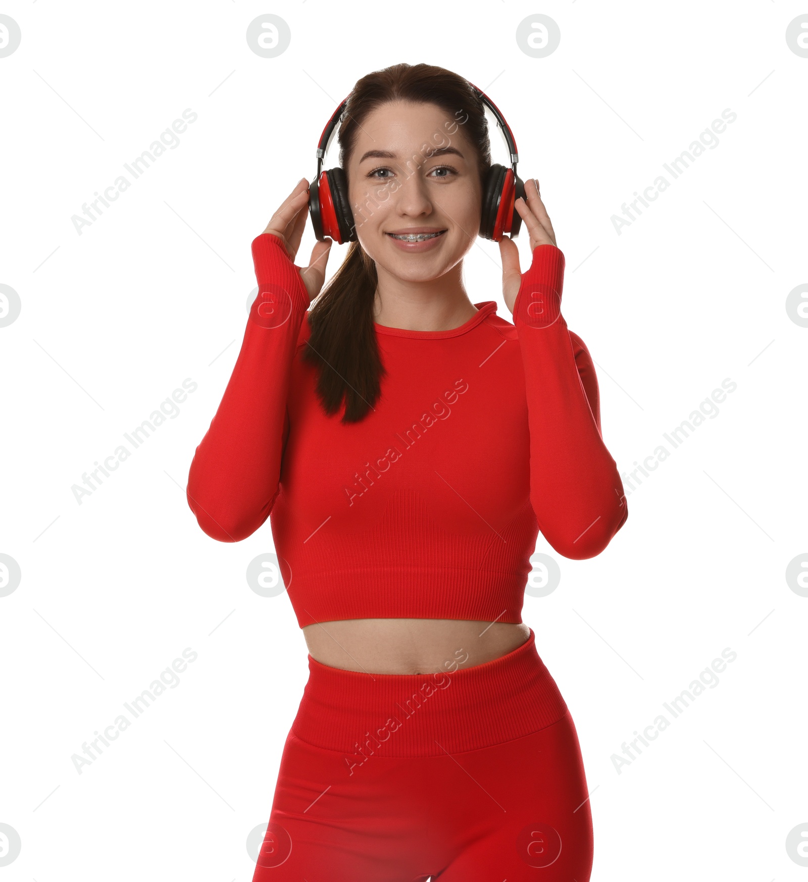 Photo of Woman in sportswear and headphones on white background