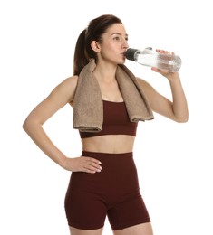 Photo of Woman in sportswear drinking water on white background