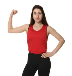 Woman in sportswear showing her bicep on white background