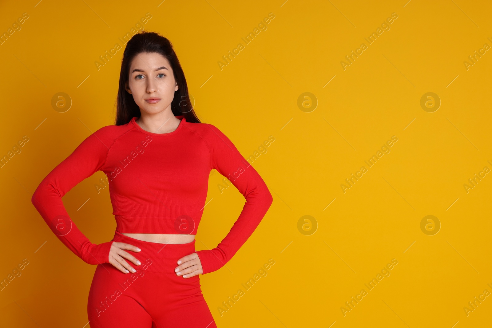 Photo of Portrait of woman in sportswear on orange background, space for text