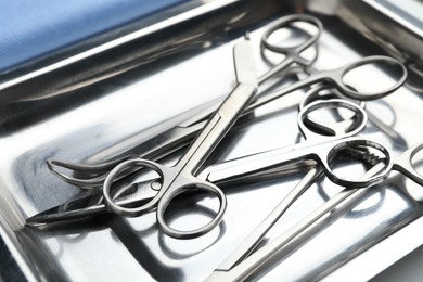 Photo of Different surgical tools in metal tray, closeup