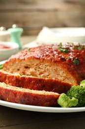 Photo of Delicious baked turkey meatloaf with broccoli on table, closeup