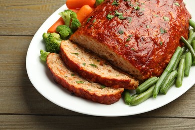 Photo of Delicious baked turkey meatloaf with vegetables on wooden table, closeup