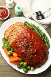 Photo of Delicious baked turkey meatloaf with vegetables served on wooden table, flat lay